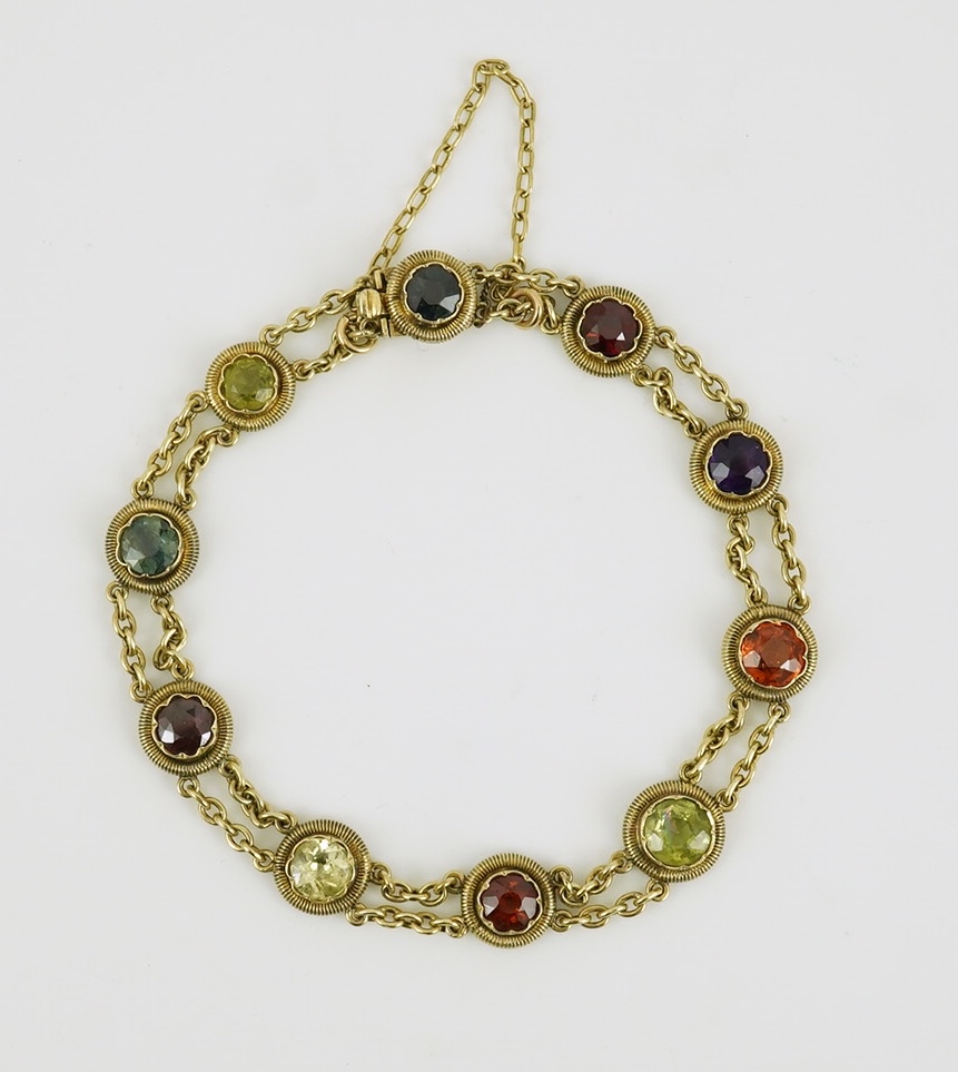 An early 20th century yellow metal and ten stone multi gem set chain link bracelet